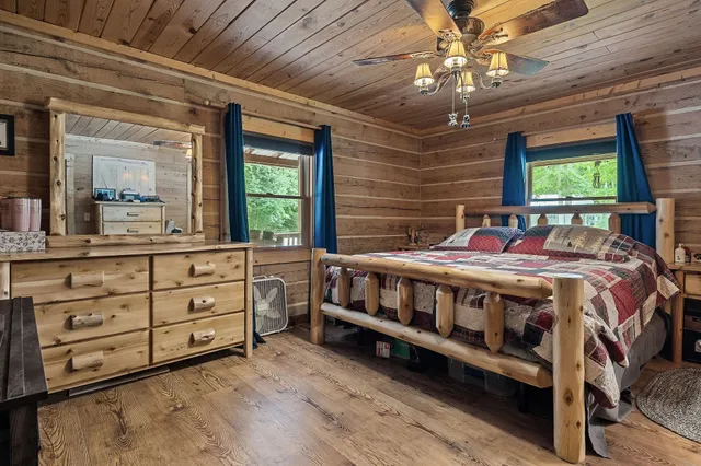 a view of a patio with table and chairs with wooden floor and fence