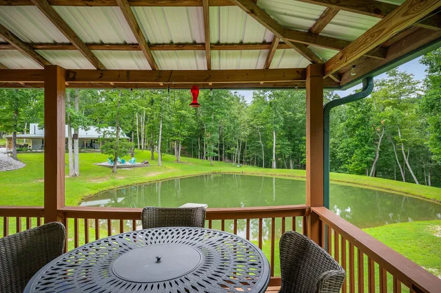 a view of a house with a yard and sitting area