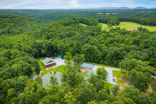 a living room with furniture a flat screen tv and kitchen view