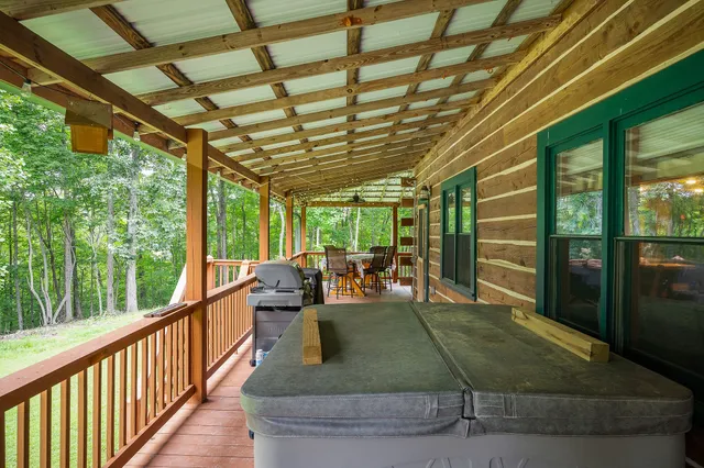 a bedroom with a bed a chandelier and dresser