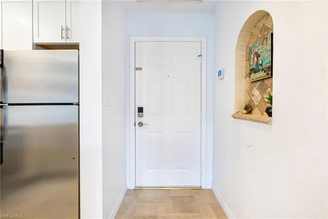 a living room with furniture and a dining table