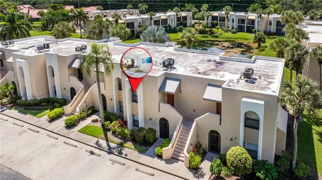 a backyard of a house with a yard and outdoor seating