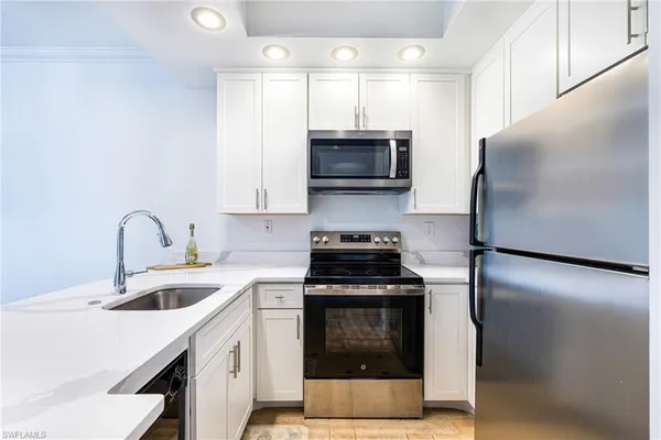 a kitchen with a sink a stove and refrigerator