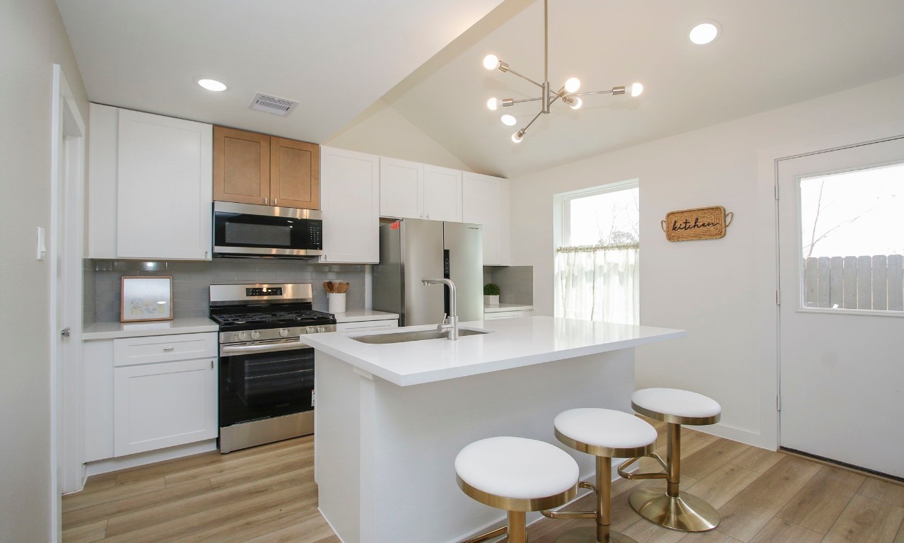 2717 Discovery Trails Conroe, TX 77301 - Photo 15 of 46 a kitchen with stainless steel appliances a sink a stove a refrigerator dining table and chairs