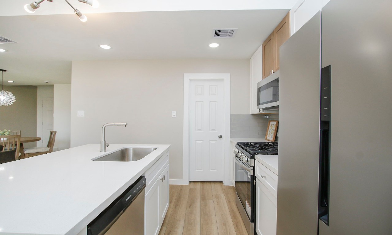 2717 Discovery Trails Conroe, TX 77301 - Photo 18 of 46 a kitchen with a sink and a refrigerator