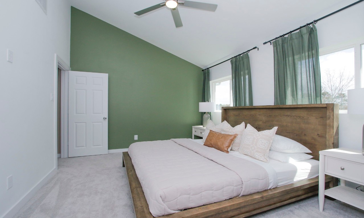 2717 Discovery Trails Conroe, TX 77301 - Photo 24 of 46 a bedroom with a bed and a chandelier