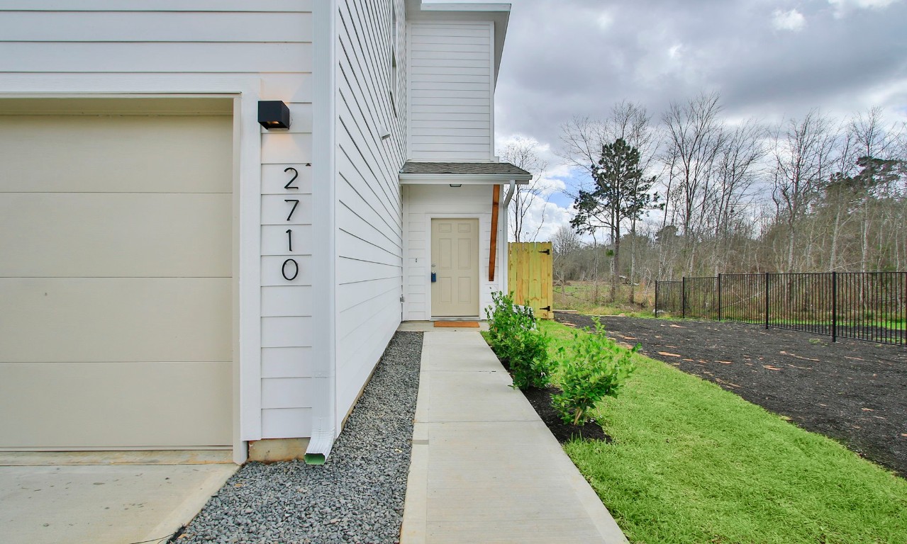 2717 Discovery Trails Conroe, TX 77301 - Photo 5 of 46 a view of a pathway of a house with a yard