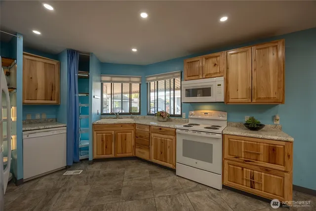 a kitchen with stainless steel appliances granite countertop a stove and a refrigerator