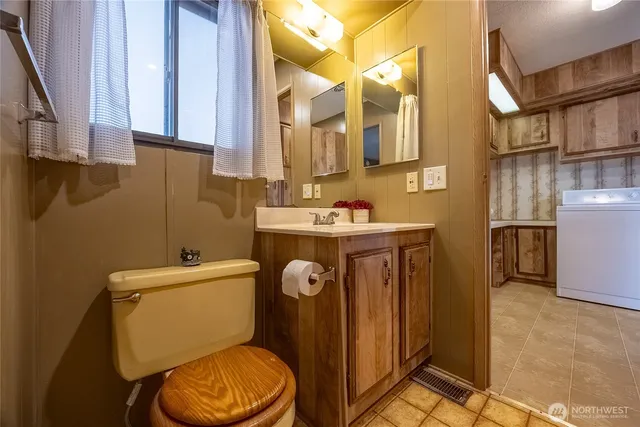 a bathroom with a toilet a sink and a mirror