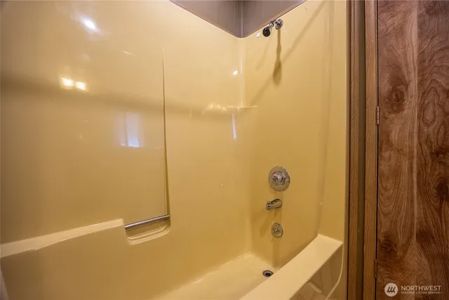 a bathroom with a tub and a shower