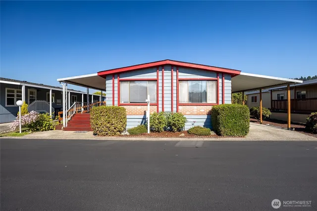 a front view of a house with a yard and potted plants