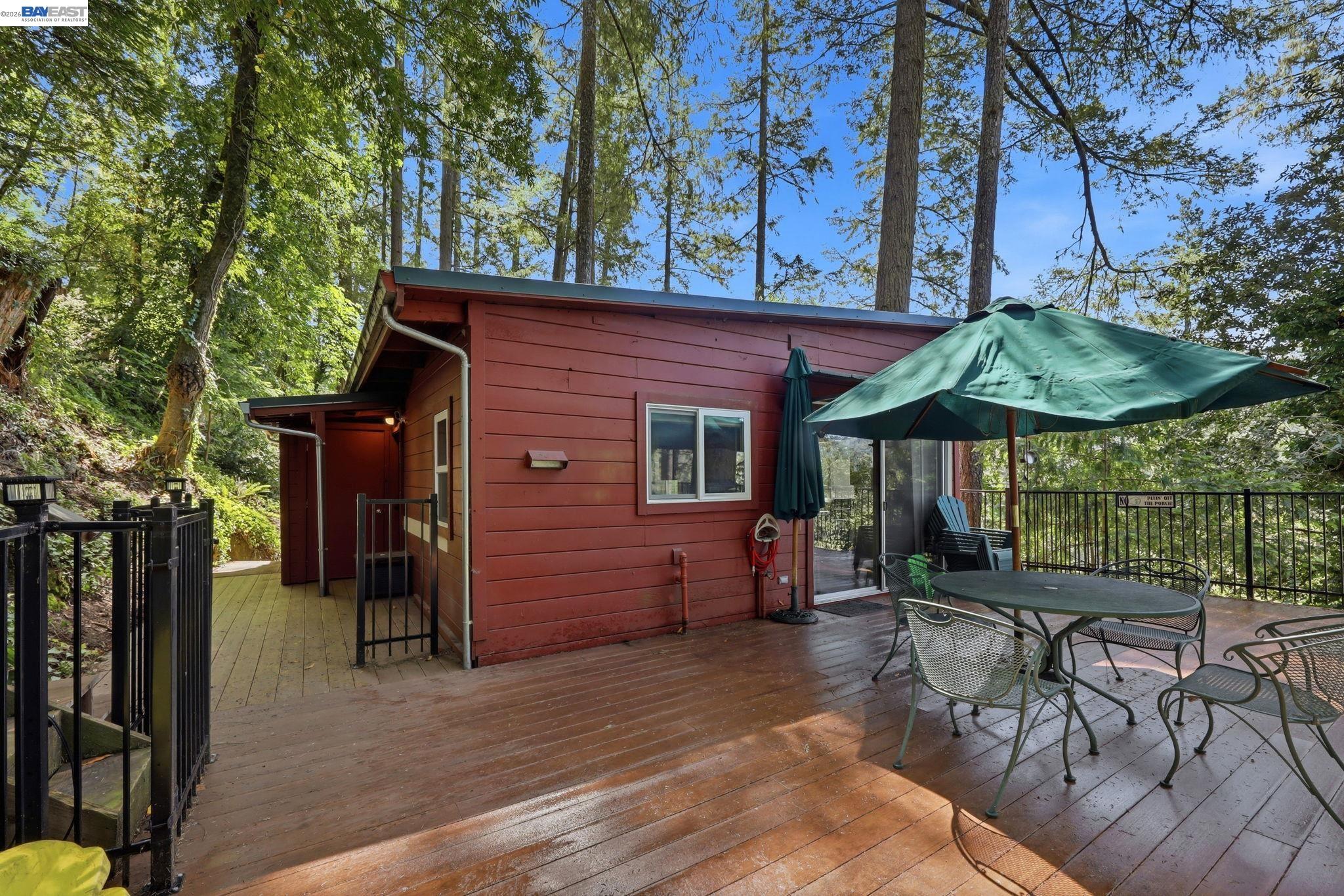 11700 Oak Road Forestville, CA 95436 - Photo 15 of 20 a patio with a table and chairs under an umbrella