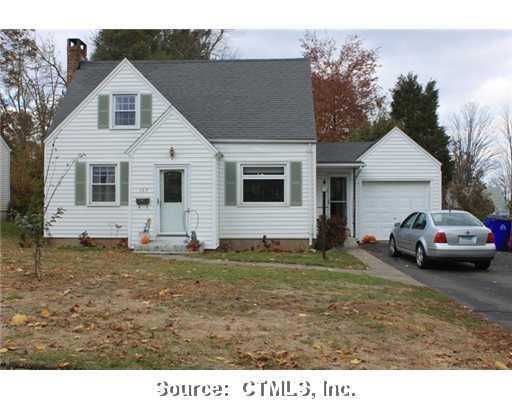 169 Beverly Road Wethersfield, CT 06109 - Photo 1 of 1 a white house covered with tall trees