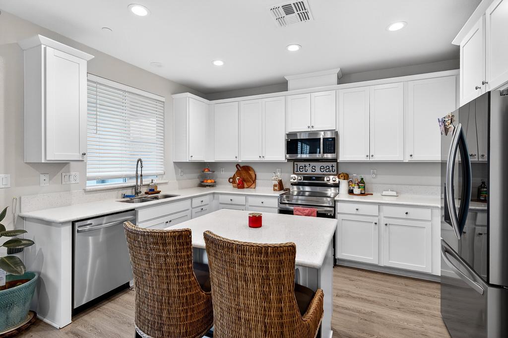 1397 Rio Grande Drive Plumas Lake, CA 95961 - Photo 17 of 54 a kitchen with a stove a sink and a refrigerator