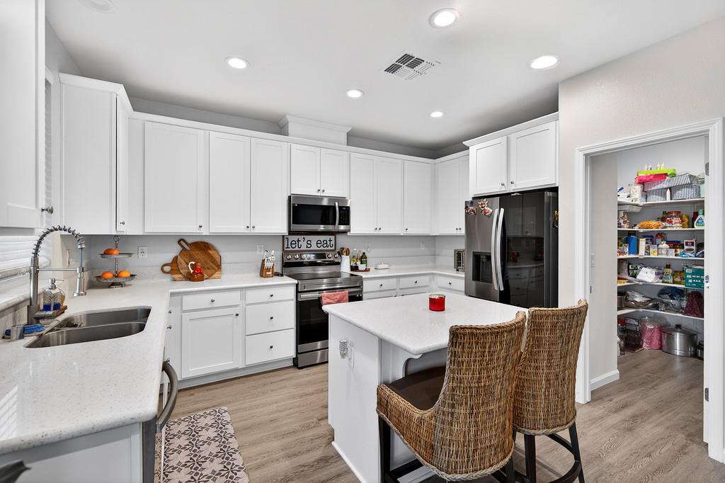 1397 Rio Grande Drive Plumas Lake, CA 95961 - Photo 18 of 54 a kitchen with a refrigerator a stove a sink and a refrigerator