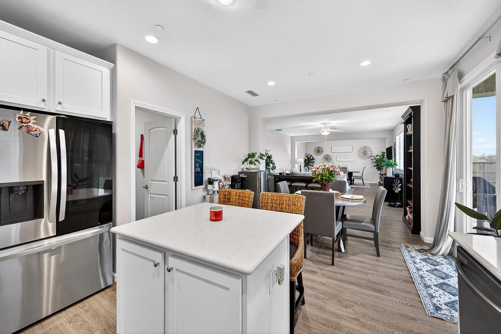 1397 Rio Grande Drive Plumas Lake, CA 95961 - Photo 19 of 54 a kitchen with stainless steel appliances a white table chairs and a refrigerator