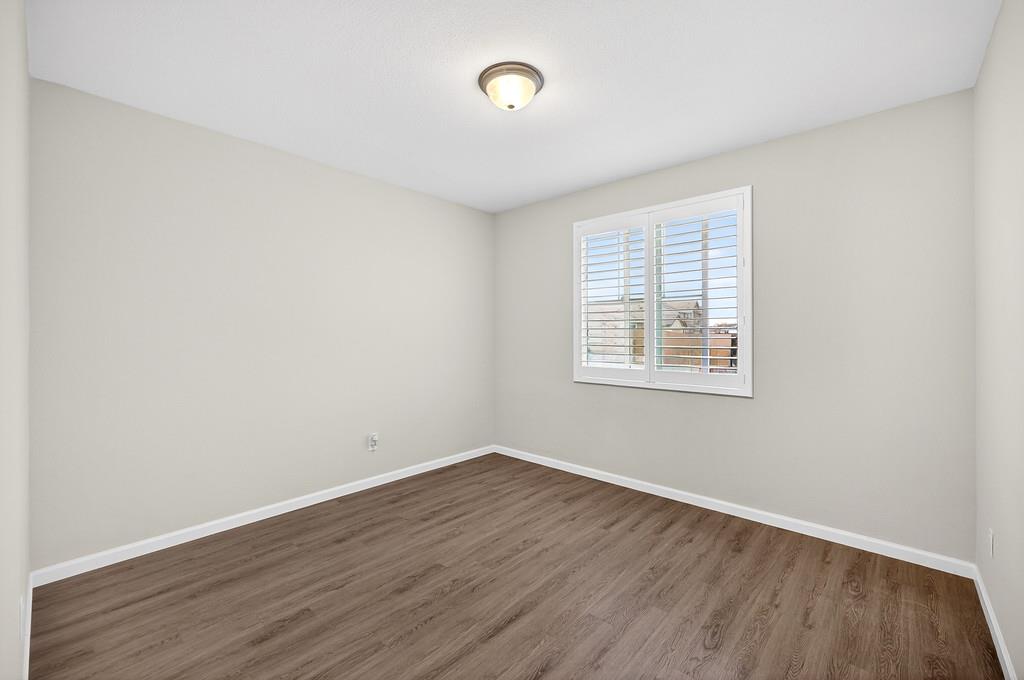 1397 Rio Grande Drive Plumas Lake, CA 95961 - Photo 21 of 54 an empty room with wooden floor and windows