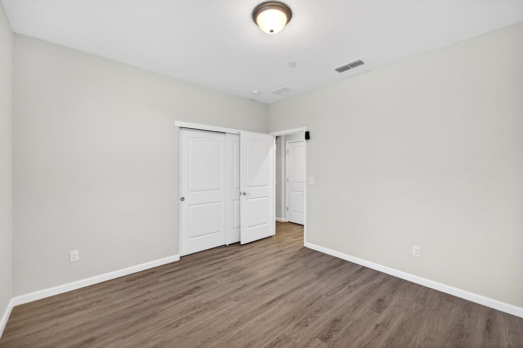 1397 Rio Grande Drive Plumas Lake, CA 95961 - Photo 22 of 54 a view of an empty room with wooden floor