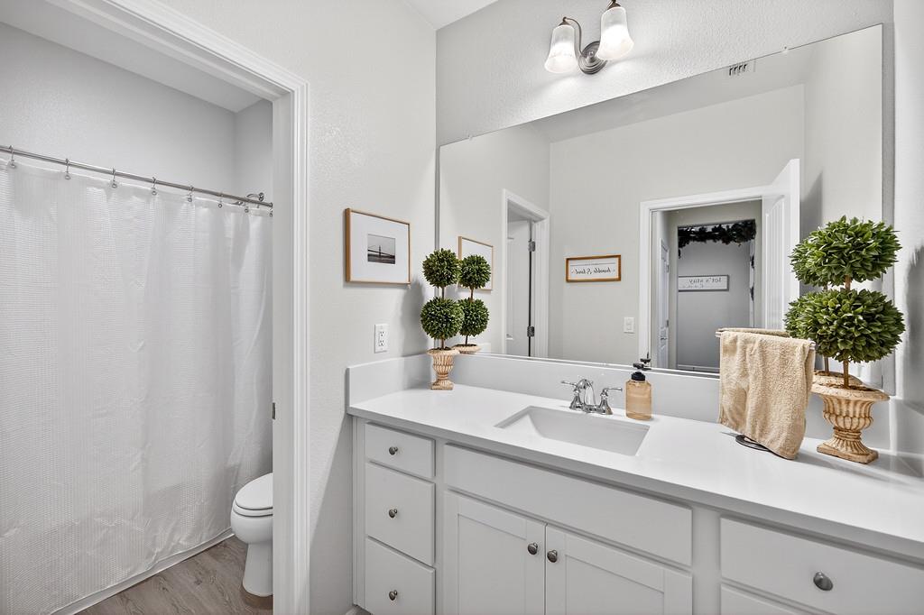 1397 Rio Grande Drive Plumas Lake, CA 95961 - Photo 23 of 54 a bathroom with a sink a toilet and a mirror