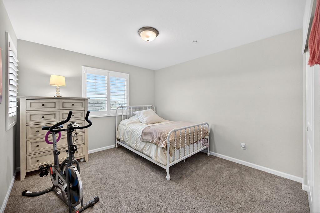 1397 Rio Grande Drive Plumas Lake, CA 95961 - Photo 30 of 54 a room with a bed a table and a window