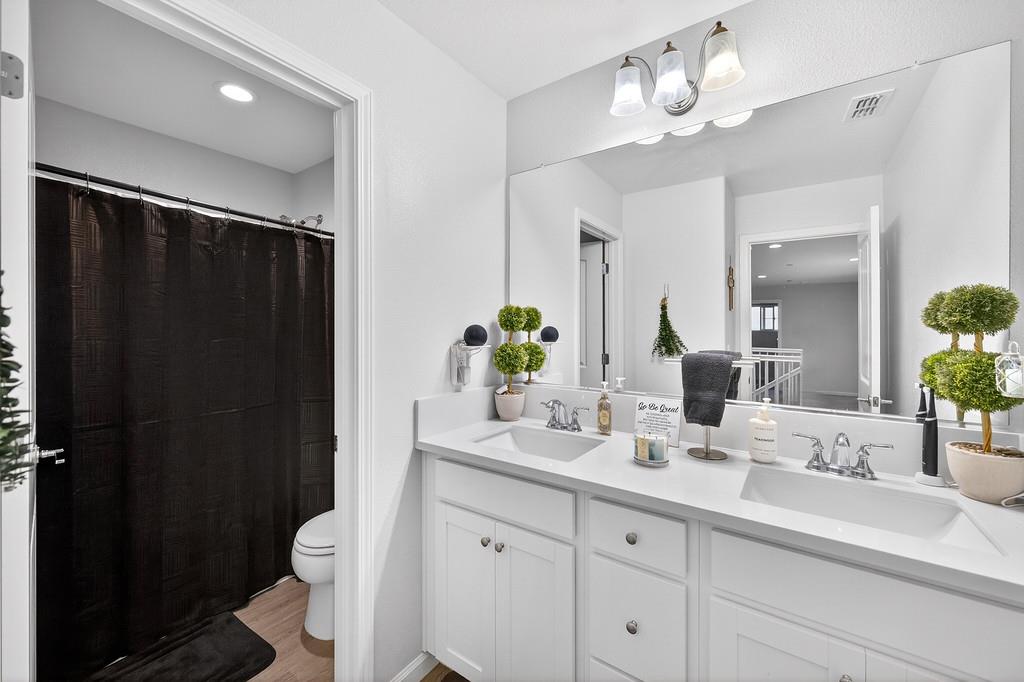 1397 Rio Grande Drive Plumas Lake, CA 95961 - Photo 36 of 54 a bathroom with a double vanity sink toilet and shower