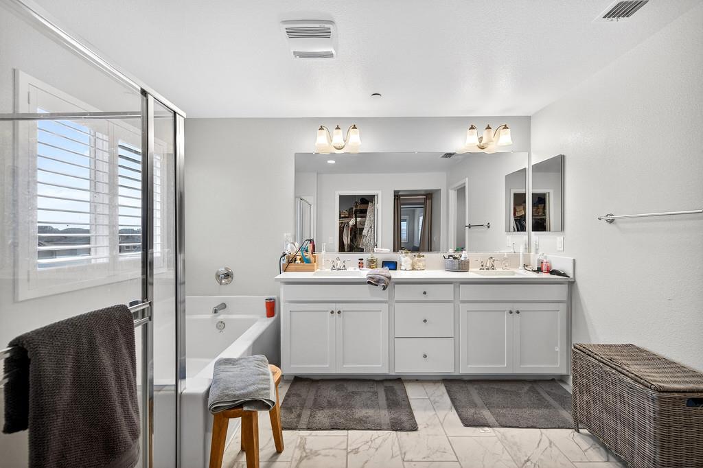 1397 Rio Grande Drive Plumas Lake, CA 95961 - Photo 44 of 54 a spacious bathroom with a granite countertop sink mirror and bathtub