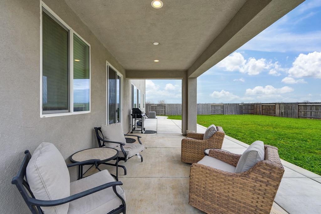 1397 Rio Grande Drive Plumas Lake, CA 95961 - Photo 47 of 54 a living room with patio furniture and a garden