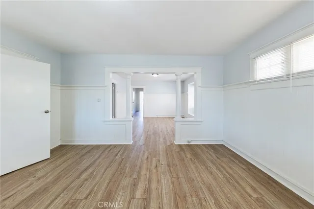 wooden floor in an empty room with a window