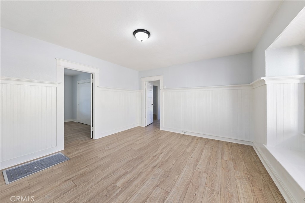 15323 Paramount Boulevard Paramount, CA 90723 - Photo 15 of 72 an empty room with wooden floor and windows