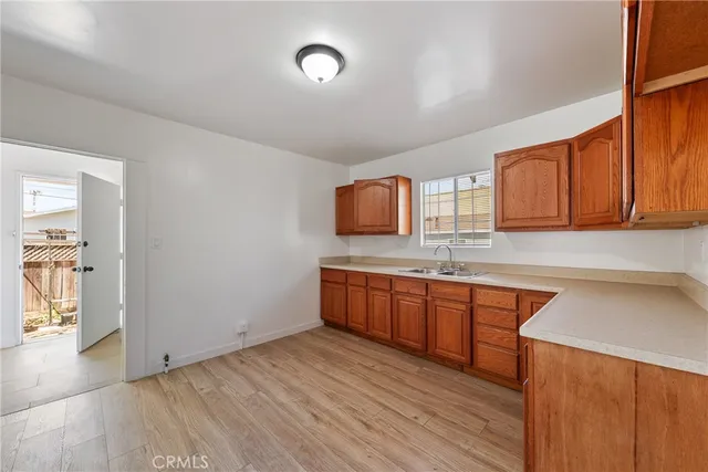 a kitchen with stainless steel appliances granite countertop wooden cabinets a sink and dishwasher