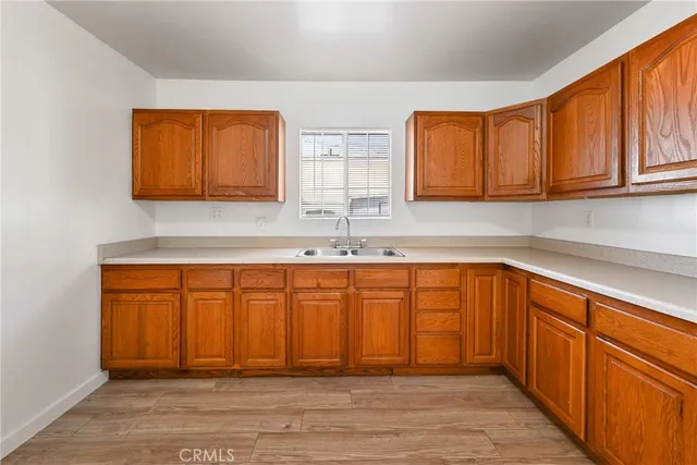a kitchen with stainless steel appliances granite countertop wooden cabinets a sink and dishwasher
