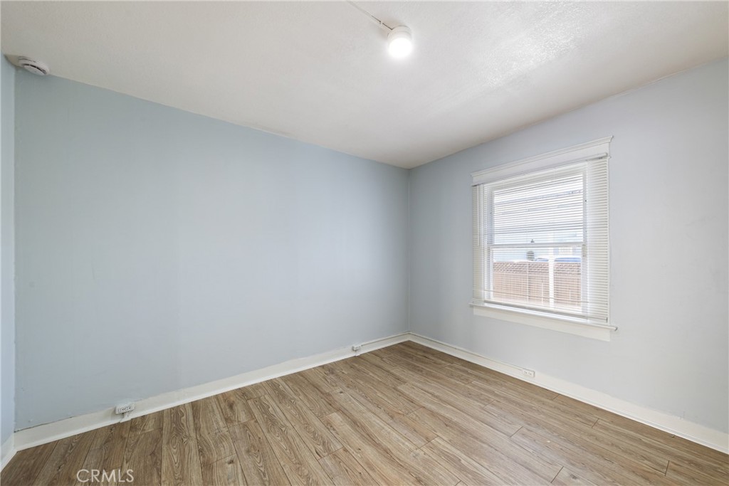 15323 Paramount Boulevard Paramount, CA 90723 - Photo 24 of 72 an empty room with wooden floor and windows