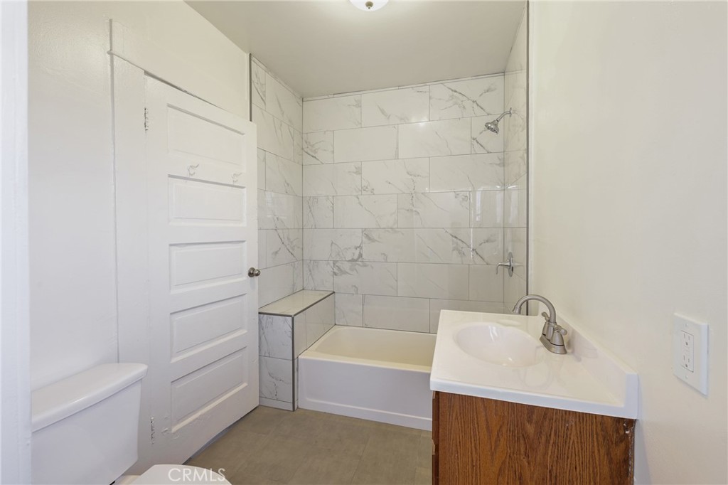 15323 Paramount Boulevard Paramount, CA 90723 - Photo 28 of 72 a bathroom with a sink a toilet and bathtub