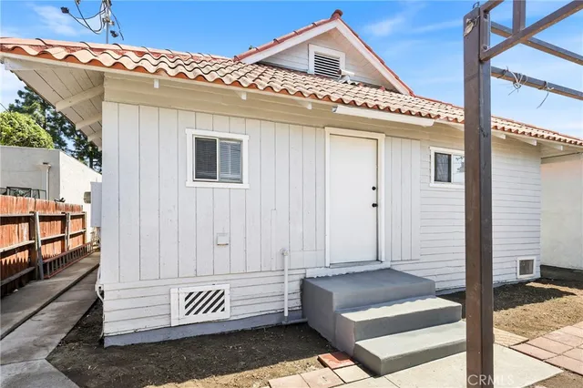 a view of a house with backyard porch and sitting area