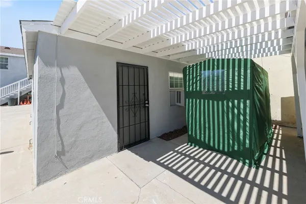 a white house with tree in front of it