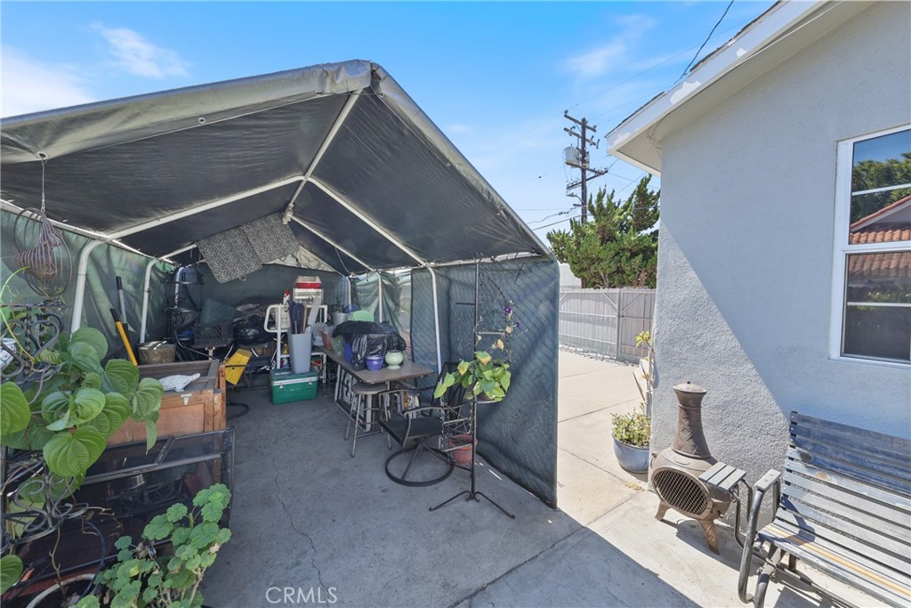 15323 Paramount Boulevard Paramount, CA 90723 - Photo 56 of 72 a view of a patio with table and chairs potted plants