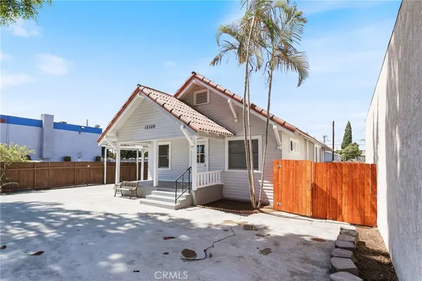 a view of a house with wooden fence