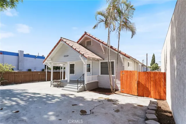 a view of a house with wooden fence