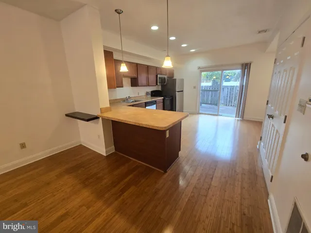 a view of kitchen with sink microwave and refrigerator