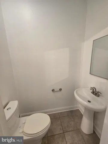 a white toilet sitting next to a bathroom sink