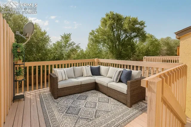 a view of a roof deck with couches and wooden floor