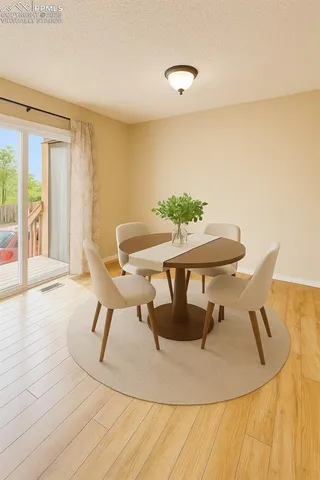 a dining room with furniture and wooden floor