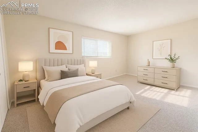 a spacious bedroom with a bed and a cabinets