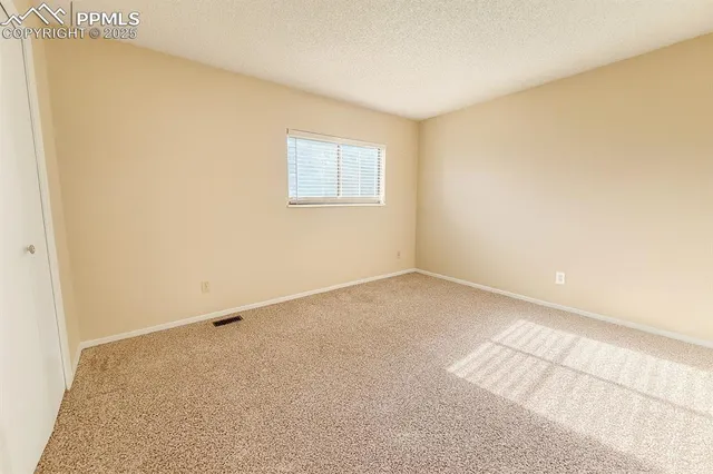 an empty room with a empty space and a window