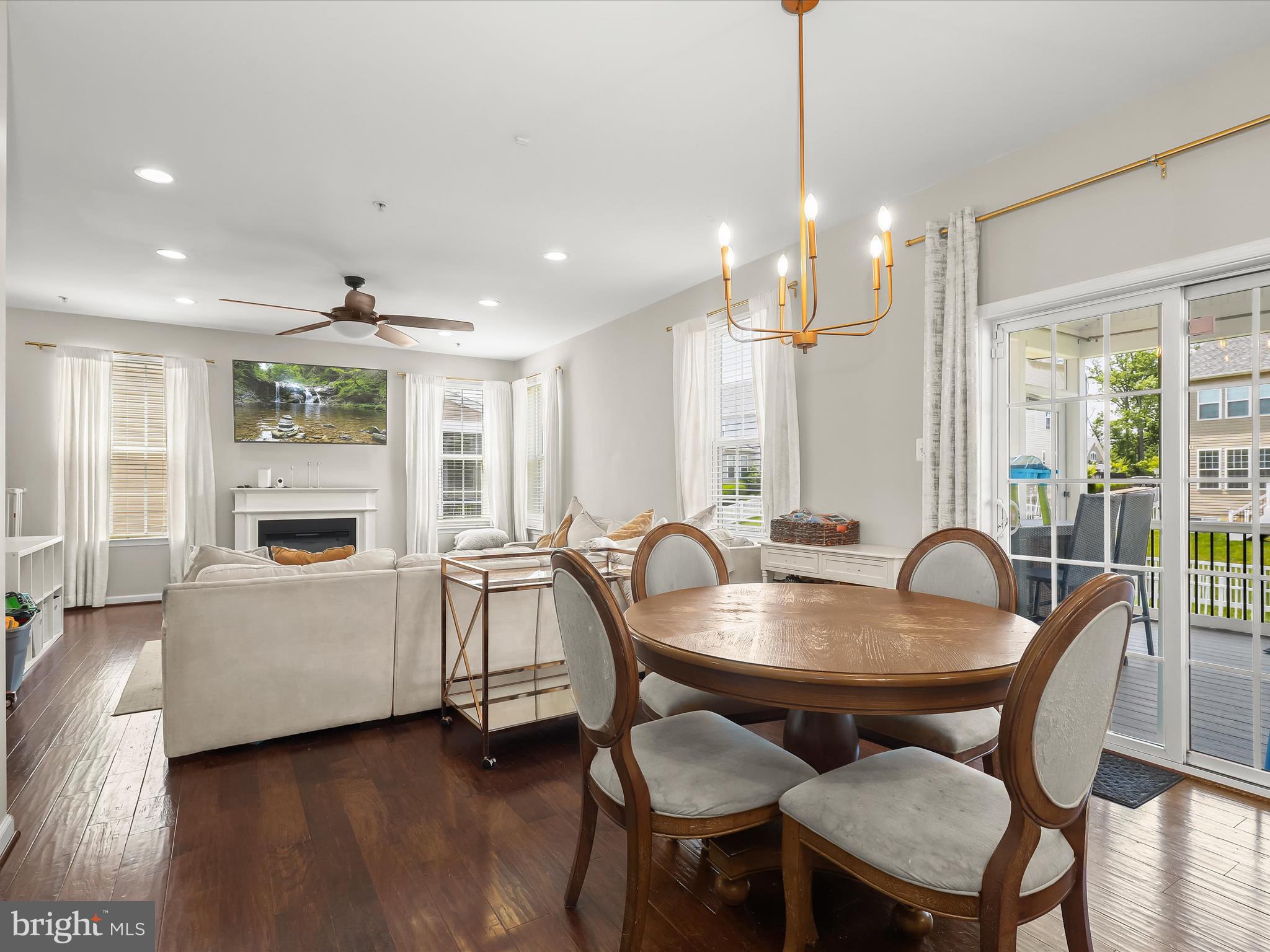 10508 Braddock Run Road Baltimore, MD 21220 - Photo 14 of 54 a dining room with furniture a chandelier and wooden floor