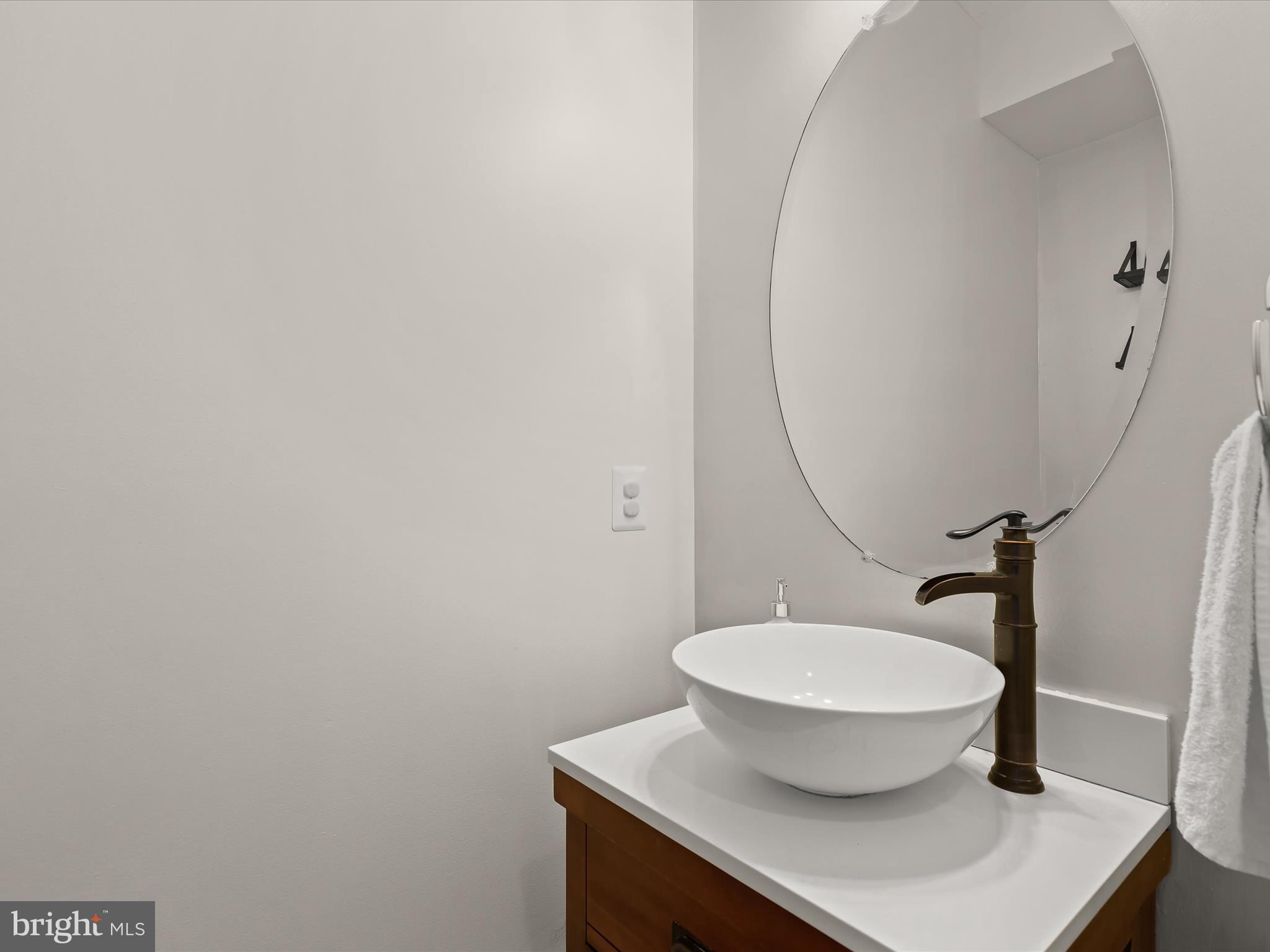 10508 Braddock Run Road Baltimore, MD 21220 - Photo 20 of 54 a bathroom with a sink toilet and a mirror