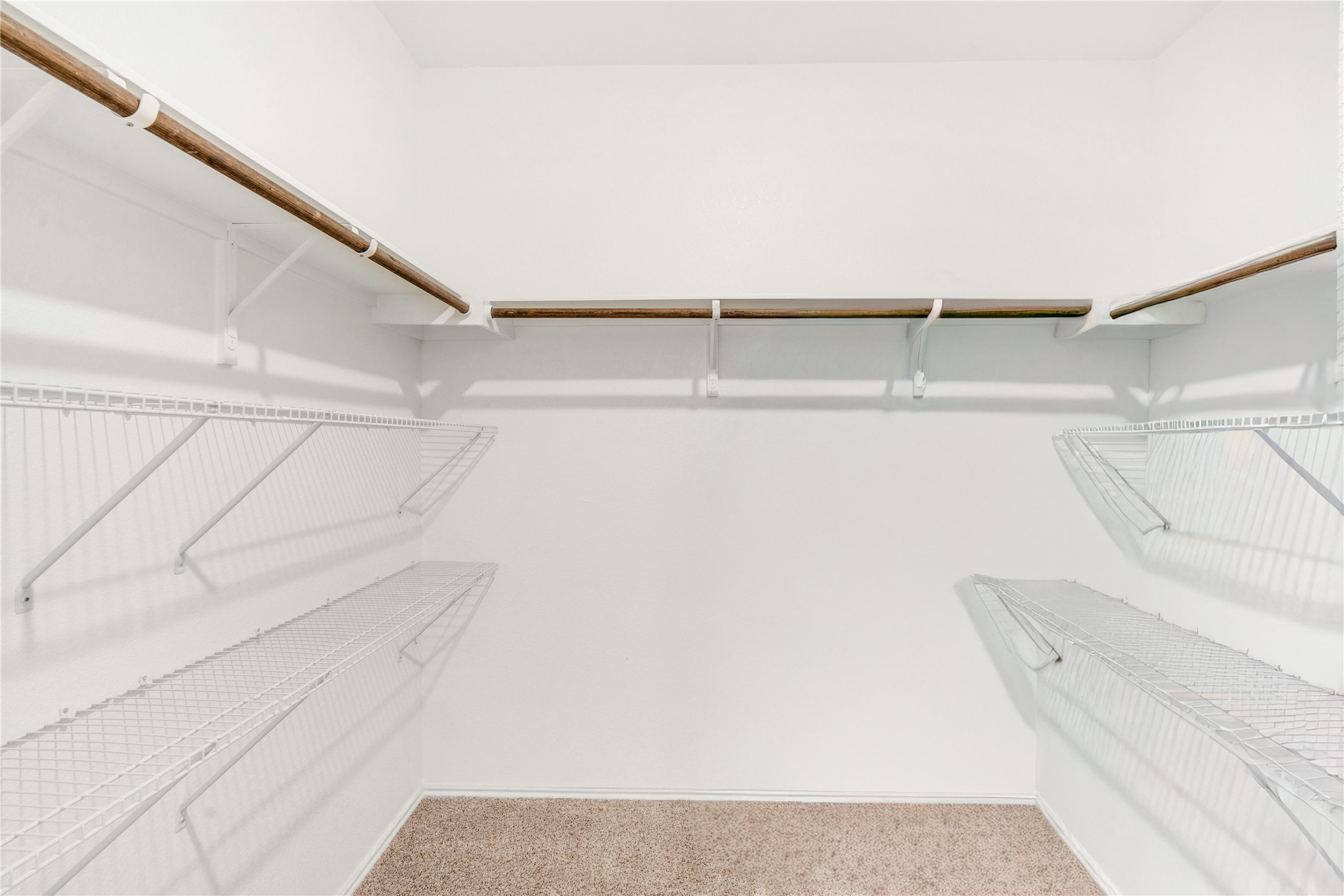 212 Saddle Mountain Road Georgetown, TX 78628 - Photo 25 of 30 An organized closet featuring ample shelving and hanging rods.