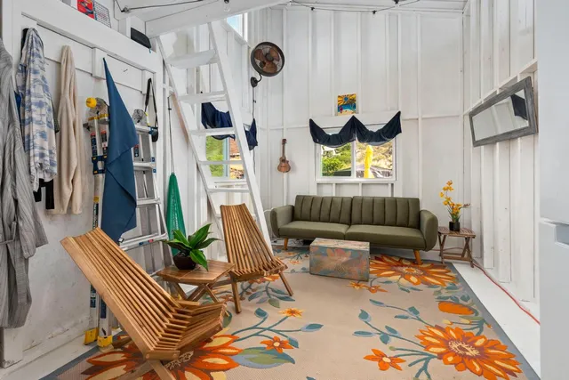 a view of a livingroom with furniture and windows