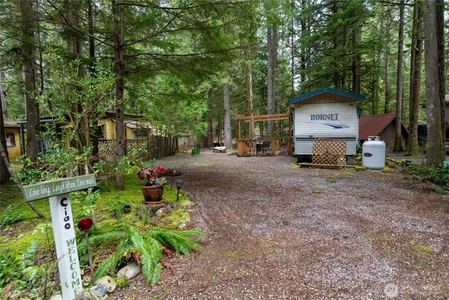 a view of a house with a patio and a yard