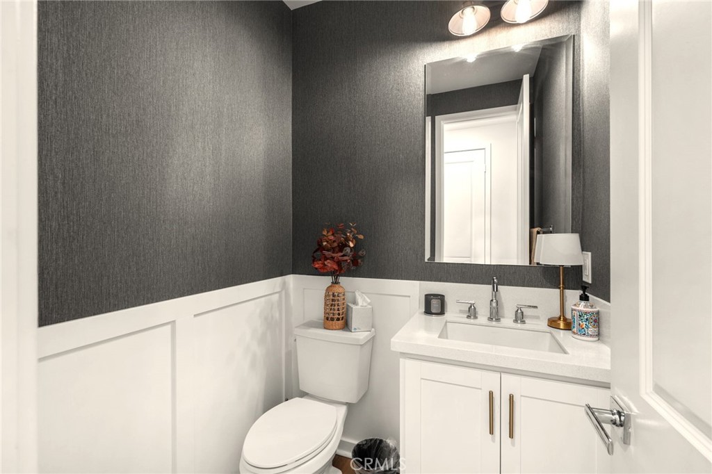 16155 New Canaan Court Riverside, CA 92504 - Photo 16 of 26 a bathroom with a sink a toilet and mirror